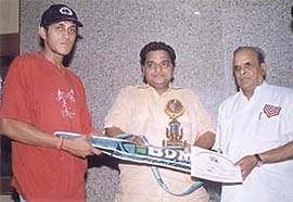 Deepankar Malviya receiving the man of the match award from Prem Chand Garodia in the Hari Aggarwal Cricket Tournament at the Karnail Singh Stadium.