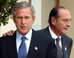 French President Jacques Chirac (R) puts his hand on US President George W. Bush's shoulder on the terrace of the Royal Parc Hotel
