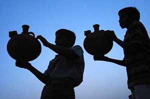 Potters check earthen pots in Amritsar on Tuesday.