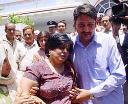 Mother of Flt. Lt. Deepakar Singh Jamwal weeps as the body of his son is been taken for cremation