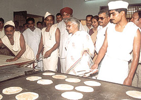WHAT’S COOKING? Delhi Chief Minister Sheila Dikshit taking a dekko at the ‘chapatis’ made by the prisoners after the inauguration of Jail No. 7 at Tihar in the Capital on Friday. Photo by Kamal Singh