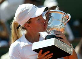 Justine Henin-Hardenne of Belgium kisses her trophy after winning the womens final of the French Open tennis tournament