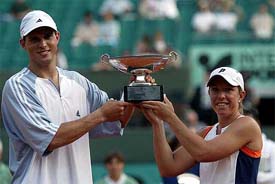 USA's Lisa Raymond, right, and compatriot Mike Bryan hold their trophy