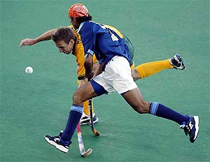 Australia's Liam De Young tackles India's Kanwalpreet Singh