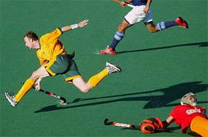 Australia's Andrew Smith trips over Indian goalkeeper Devesh Chauhan