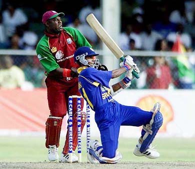 Upul Chandana of Sri Lanka hits a boundary as West Indies' wicketkeeper Ridley Jacobs looks on