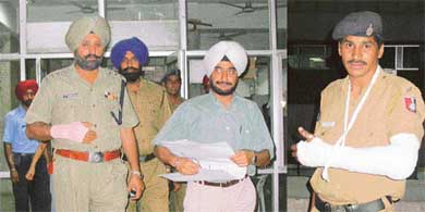 DSP S.S. Randhawa and ADC Inderjit Singh Sandhu, who were injured, come out of the GMCH, Sector 32