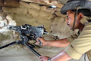 A BSF jawan keeps vigil from a bunker in R. S. Pura sector