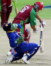 Sri Lankas wicketkeeper Romesh Kaluwitharana holds his face