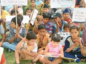 Students of different schools sit in dharna in protest against the fee hike in front of the Deputy Commissioners office