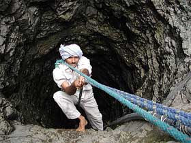 A man climbs out of a well at Chuda Chokadi village