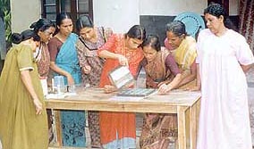 Members of the Mararikulam Experiment pour soap mixture into a mould