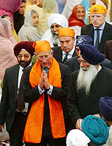 Britain's Prince of Wales (C) walks through crowds of Sikh worshippers