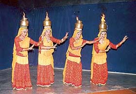 Physically challenged children from Shailajs institute "Baisakhi" sport burning vessels as they perform chari --- a Rajasthani folk dance at Pracheen Kala Kendra