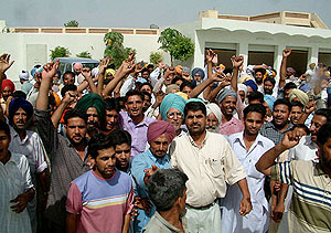 Villagers raise slogans against the VB raid on Mr Natrottam Singh Dhillons house in Badal village on Sunday.
