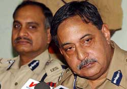 Director-General of Police Gopal Sharma flanked by Inspector-General of Police  K. Rajandaran