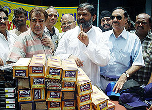 Members of the Rotary Club, Ambala, distribute shoes and caps to sanitation workers