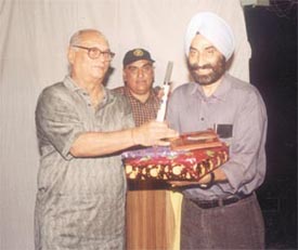 Delhi and District Cricket Association joint secretary Dr S S Sareen presenting a memento to Board of Control for Cricket in India joint secretary Jyoti Bajpai 