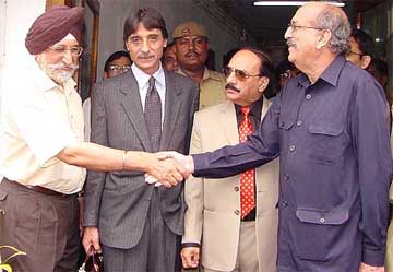 The Chief Managing Director of the DTC, Mr A.J.S. Shahan, shakes hand with Mr Azfar Shafqat