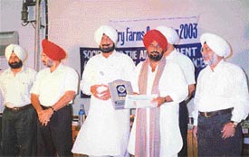 Mr Sarabjit Singh, a dairy farmer, receives a prize from Mr Jagmohan Singh Kang, Minister for Animal Husbandry