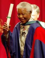 Former South African President Nelson Mandela smiles after being conferred with an Honorary Doctorate of Laws