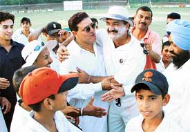 Yograj Singh, a former test cricketer, shares a lighter moment with former Ranji player Rakesh Jolly during the final of the UT League Cricket Tournament