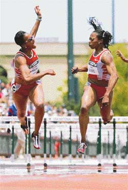 Gail Devers beats Miesha Mc Kelvy-Jones by 1/100th of a second to win the 100m hurdles in 12.61