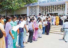 Students line up to submit forms for admission to Class XI in government schools