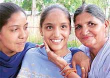 Rajinder Kaur being hugged by her mother Gurnam Kaur and sister Paramjit Kaur 