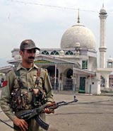 A policeman patrols in front of the Hazratbal shrine
