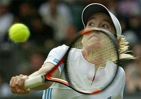 Justine Henin-Hardenne of Belgium plays a return to Italy's Flavia Pennetta