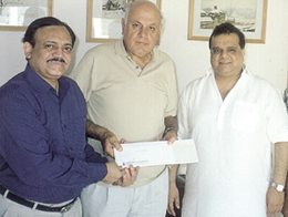 DDCA vice-president C. K. Khanna presenting a memento to Dr Farooq Abdulla, who has been re-elected president of the Jammu and Kashmir Cricket Association, watched by Mr Narender Batra.