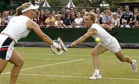 Multiple Wimbledon champion Martina Navratilova and her doubles partner Svetlana Kuznetsova of Russia compete for a return
