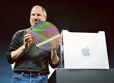 Apple CEO Steve Jobs holds up 12-inch computer chip for the new Apple Power Mac G5 personal computer, while introducing it to the world at the Apple World Wide Developers Conference in San Francisco