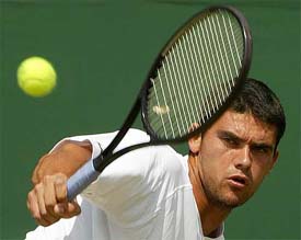 Australia's Mark Philippoussis plays a return to Radek Stepanek of the Czech Republic in their third round match