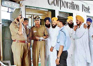 Chandigarh policemen guard entry to the first floor of a shop-cum-office building