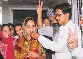 Ms Manjit Kaur, the youngest woman sarpanch in the district, is being offered sweets after she was declared elected