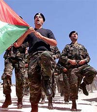 Palestinian special forces carry a Palestinian flag during the last training session 