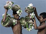Boys carry waterlilies, the national flower of Bangladesh