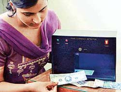 An engineer gives a demonstration of the fake currency detector developed by the CSIO in Chandigarh on Thursday.