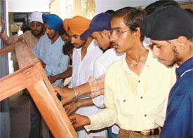 Students check the admission lists in the Government College for Boys