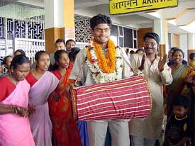 Vimal Lakhra, a member of the victorious Indian Hockey team plays madal