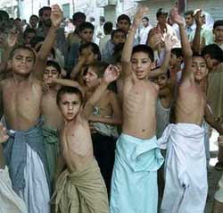 Children from Shi'ite Muslim sect beat their chests to mourn the victims of Friday's suicide attack on a mosque in Quetta