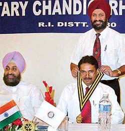 Dr G.S. Kochhar, outgoing president, installs the new president for 2003-2004 Mr Bachitter Singh at a Rotary Chandigarh Shivalik installation function at Hotel Shivalik in Sector 17, Chandigarh