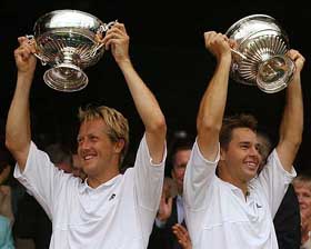 Todd Woodbridge of Australia and Jonas Bjorkman of Sweden hold aloft their trophies after winning the men's doubles title 