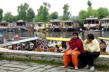 Tourists enjoy monsoon at the bank of the Dal Lake in Srinagar 