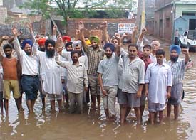 Residents of the Jaimal Singh road area protest against accumulation of rainwater