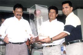 DTC cricket team captain Mahesh Sharma and vice-captain Bhuwan Chand Kandpal receiving the DDCA A-II Division Championship trophy from DDCA vice-president Chetan Chauhan at the awards function at the Ferozeshah Kotla ground.