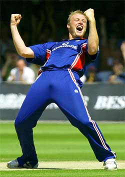 England's Andrew Flintoff celebrates the dismissal of South Africa's Sean Pollock