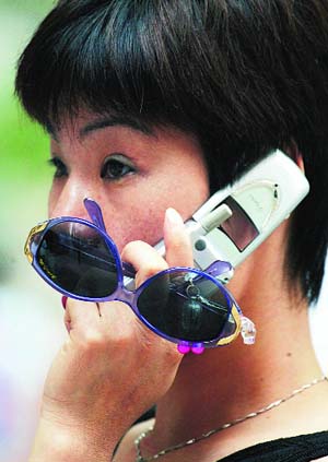A Chinese woman chats on her mobile phone in Shanghai.